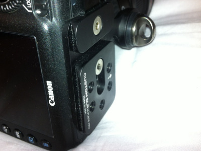 Photograph of the M-Plate Pro attached to a Canon camera viewed from the side